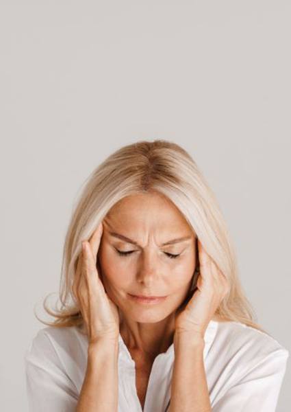 Mature woman struggling with headache