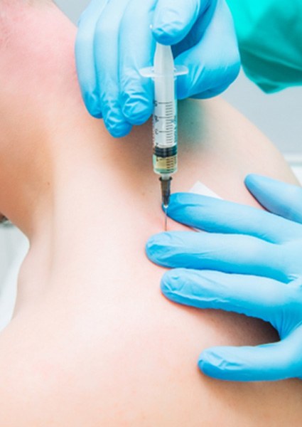 patient getting amniotic growth factors injected into neck