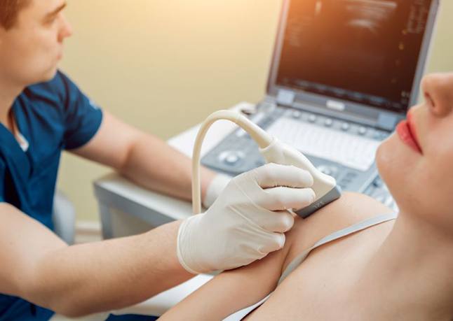Ultrasound tech examining woman’s shoulder