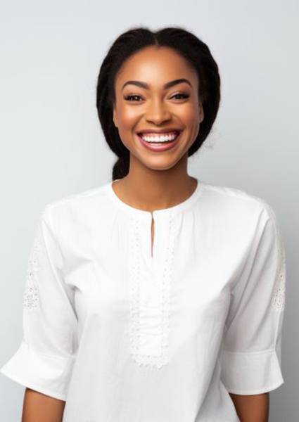 Portrait of smiling young woman against gray background