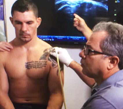 Doctor Stein examining patient's shoulder