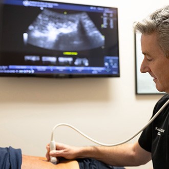 Doctor performing a musculoskeletal ultrasound