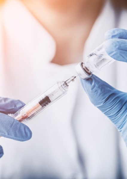 Doctor putting Whartons Jellytic growth factors into syringe