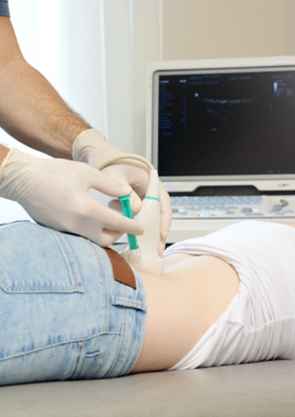 doctor injecting amniotic growth factors into woman’s lower back 
