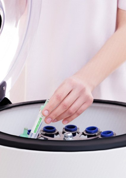 doctor pulling PRP out of a centrifuge 