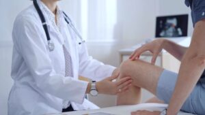Man visiting orthopedic doctor for knee treatment