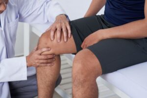Doctor examining patient’s knee
